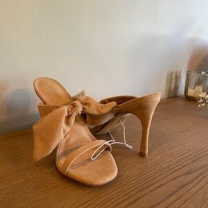 New with tags Express tan suede heels with bow detail.